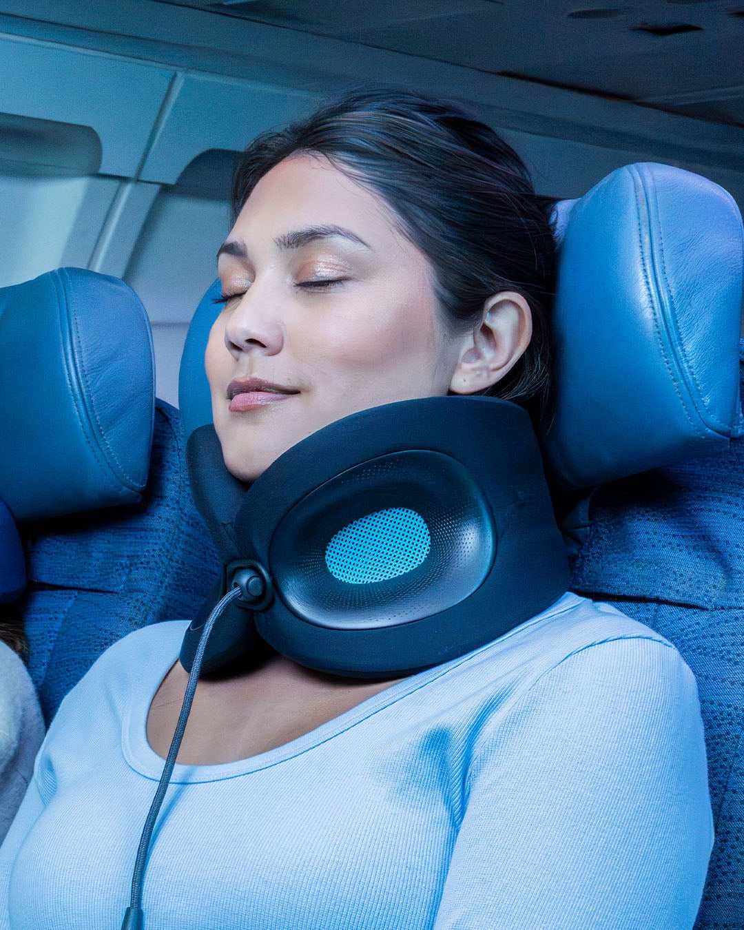 Woman on flight sleeping comfortably with Evolution X neck pillow