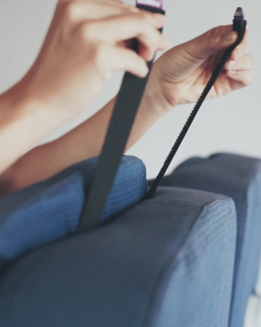 securing Seat Straps around plane head rest to keep pillow in place